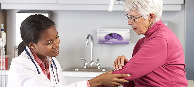 Doctor examining elbow